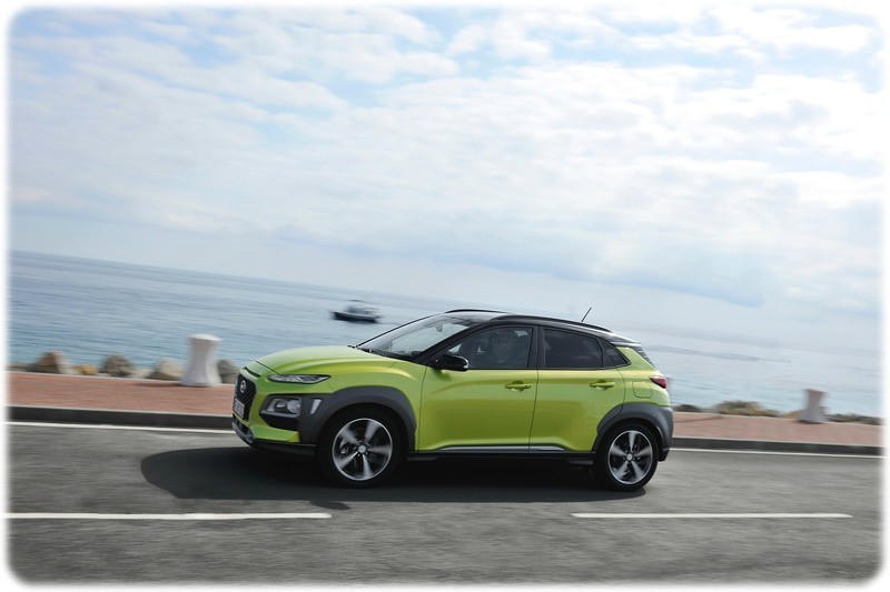 2018 Hyundai Kona in Acid Yellow driving along a coastal road