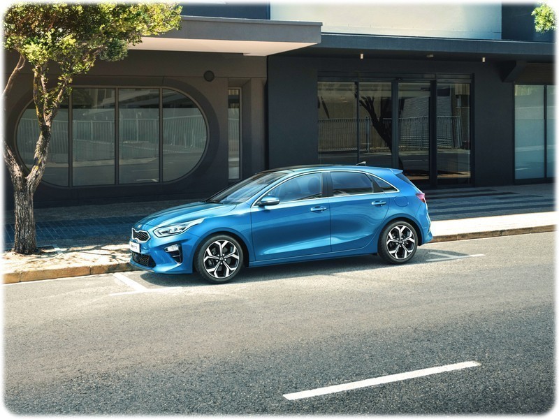 The new 2018 Kia Ceed parked up on the roadside in a city, side view
