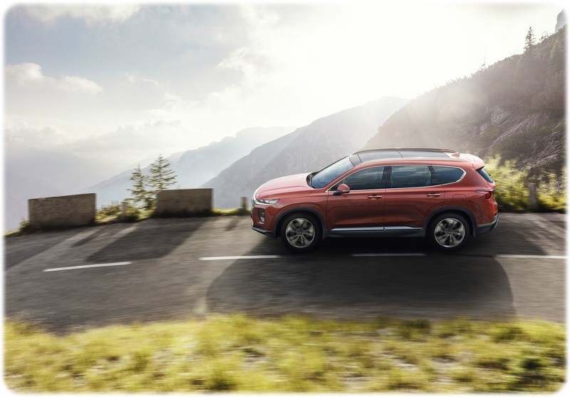 New 2018 Hyundai Santa Fe side view on a corner on a mountain cliff edge road