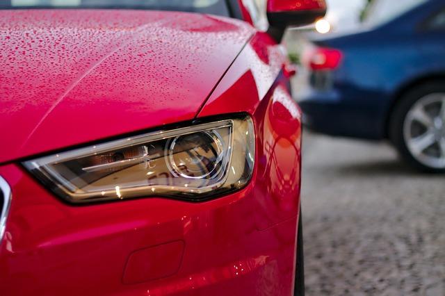 Image of a Car Headlight on a Red Car