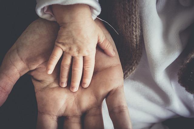 Image of a Baby and Mans Hands