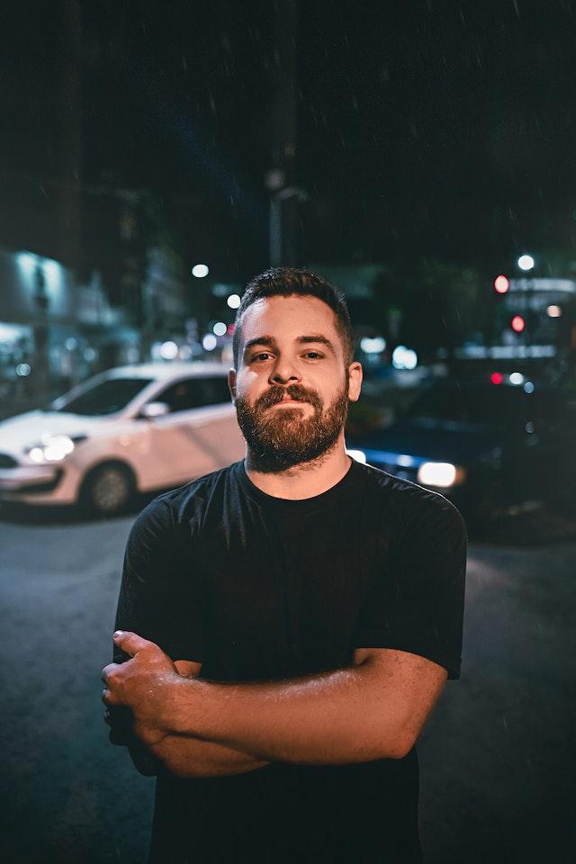 Image of a Man stood in front of a Car